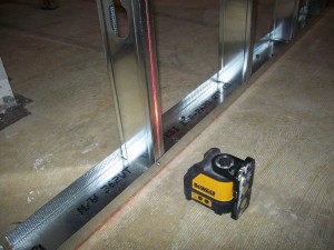 Before attaching the stud to the top track, be sure the stud is plumb.