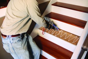 How to install hardwood stairs step 6 Install treads using construction adhesive and finish nails.