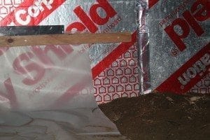 To seal this crawl space, a vapor barrier was applied along the floor and up the walls