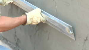 Using a straight board or darby, screed the surface