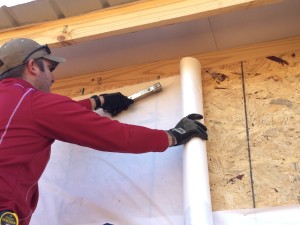 Installing plywood sheathing and house wrap