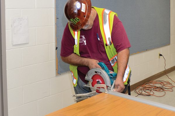 Protect the door’s finish with painter’s tape along the cut line.
